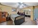 Bedroom featuring a bed, a ceiling fan, dresser, mirrored sliding-door closet, and glimpses into the adjacent rooms at 405 Longtree Ave, Henderson, NV 89011