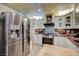 Cozy kitchen featuring stainless steel appliances, ample cabinet space, and unique backsplash at 405 Longtree Ave, Henderson, NV 89011