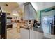 Well-equipped kitchen with white cabinets, granite countertops, and stainless steel appliances, designed for cooking convenience at 405 Longtree Ave, Henderson, NV 89011