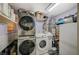 Efficient laundry room including stacked washer and dryer units and plenty of storage at 405 Longtree Ave, Henderson, NV 89011