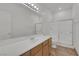 Bathroom features a long vanity with wood cabinets and tiled floor at 4828 Marco Polo St, North Las Vegas, NV 89031