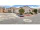 Single-story house with desert landscaping, attached two-car garage, and sidewalk access at 4828 Marco Polo St, North Las Vegas, NV 89031