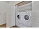 Modern laundry room with white washer and dryer set, built in shelves and ample space at 4828 Marco Polo St, North Las Vegas, NV 89031