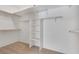 Walk-in closet with white shelving, ample storage, and neutral carpet at 4828 Marco Polo St, North Las Vegas, NV 89031