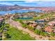Community aerial view showcasing a luxury home on the golf course, near the lake, and mature landscaping at 5 Via Ravenna Ct, Henderson, NV 89011