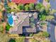Aerial view of a luxury home featuring a tiled roof, manicured backyard with a pool, and lush landscaping at 5 Via Ravenna Ct, Henderson, NV 89011