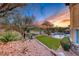 Tranquil backyard showcasing desert landscaping, artificial turf, a pool and spa, and picturesque views at 5 Via Ravenna Ct, Henderson, NV 89011