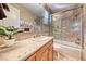 Bathroom featuring tiled walls, shower/tub, and vanity with sink at 5 Via Ravenna Ct, Henderson, NV 89011