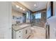 This bathroom features a granite countertop, decorative mirror, and a tub with shower combo at 5 Via Ravenna Ct, Henderson, NV 89011