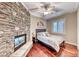 Inviting bedroom with stone fireplace, wood floors, and ample natural light at 5 Via Ravenna Ct, Henderson, NV 89011