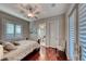 Cozy bedroom with wood floors, plantation shutters, and an ensuite bathroom at 5 Via Ravenna Ct, Henderson, NV 89011