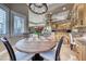 Charming breakfast nook with a round table and chandelier, adjacent to the kitchen at 5 Via Ravenna Ct, Henderson, NV 89011