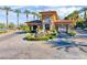 Elegant community entrance featuring lush landscaping, a water fountain, and palm trees at 5 Via Ravenna Ct, Henderson, NV 89011