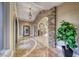 Impressive foyer featuring stone archway, marble flooring, elegant lighting, and staircase at 5 Via Ravenna Ct, Henderson, NV 89011