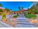 Beautiful two-story home with manicured landscaping, paver driveway, and elegant entryway with stone steps at 5 Via Ravenna Ct, Henderson, NV 89011