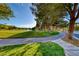 Scenic golf course view featuring lush green fairways, mature trees, and serene water features in a well-manicured landscape at 5 Via Ravenna Ct, Henderson, NV 89011