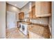 This laundry room features custom cabinets, granite countertops, and front load washer and dryer at 5 Via Ravenna Ct, Henderson, NV 89011