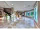Expansive living area with tiled flooring, large windows, and staircase at 5 Via Ravenna Ct, Henderson, NV 89011