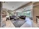 Open-concept living room with stone accents, comfortable leather furniture, and abundant natural light at 5 Via Ravenna Ct, Henderson, NV 89011