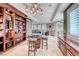 The formal living space features travertine floors, a custom bar, and a whimsical light fixture at 5 Via Ravenna Ct, Henderson, NV 89011