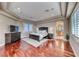 This main bedroom features a tray ceiling, hardwood floors, and an ensuite bathroom at 5 Via Ravenna Ct, Henderson, NV 89011