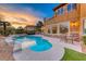 Gorgeous backyard with a custom pool, spillover spa, and inviting patio area for relaxing or entertaining guests at 5 Via Ravenna Ct, Henderson, NV 89011