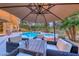 Beautiful outdoor pool and spa area featuring lounge seating, a fire pit table, and privacy landscaping at 5 Via Ravenna Ct, Henderson, NV 89011