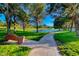 Scenic view of the walkway path with pond and fountain surrounded by grassy areas with mature trees at 5 Via Ravenna Ct, Henderson, NV 89011