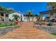 Multi-level backyard with manicured landscaping and hardscape, leading to an outdoor living area with a fireplace at 516 Arizona St, Boulder City, NV 89005