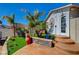 Backyard area boasting decorative artificial turf, beautiful desert landscaping and unique artistic touches at 516 Arizona St, Boulder City, NV 89005