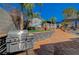 Backyard area boasting a built-in grill, outdoor lounge area, tiered landscaping, and desert foliage at 516 Arizona St, Boulder City, NV 89005