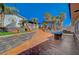 Lush backyard area with stone accents, concrete patio, landscaping, outdoor lounge space, and mature trees at 516 Arizona St, Boulder City, NV 89005