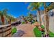Inviting backyard featuring desert landscaping, mature palm trees, and a charming outdoor living space at 516 Arizona St, Boulder City, NV 89005