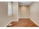 Bright bedroom featuring hardwood floors, a window with shutters, and neutral-toned walls at 516 Arizona St, Boulder City, NV 89005