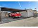 A large red truck parked in a covered carport with a detached garage in the background at 516 Arizona St, Boulder City, NV 89005