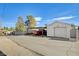 View of a garage with an attached carport, painted white with a red truck parked underneath at 516 Arizona St, Boulder City, NV 89005