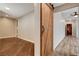 View of a hallway featuring a sliding barn door, hardwood floors, and neutral paint at 516 Arizona St, Boulder City, NV 89005