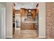 Stylish kitchen featuring wood cabinetry, stainless appliances, brick backsplash, and wood floors at 516 Arizona St, Boulder City, NV 89005