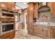 Modern kitchen featuring stainless steel appliances, double ovens, and brick backsplash at 516 Arizona St, Boulder City, NV 89005
