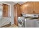 Laundry room with washer, dryer, and wooden cabinets at 516 Arizona St, Boulder City, NV 89005