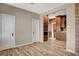 Spacious living room with wood-look flooring and view into kitchen at 516 Arizona St, Boulder City, NV 89005