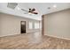 Bright living room with wood-look flooring, ceiling fan, and neutral paint at 516 Arizona St, Boulder City, NV 89005