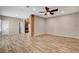 Spacious living room with wood-look flooring, ceiling fan, and neutral paint at 516 Arizona St, Boulder City, NV 89005