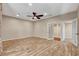 Large living room with wood-look flooring, ceiling fan, and neutral paint at 516 Arizona St, Boulder City, NV 89005