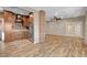 Spacious living room with hardwood floors, brick pillar, ceiling fan, and glass paneled doors at 516 Arizona St, Boulder City, NV 89005
