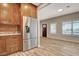 Open floor plan with hardwood floors connecting kitchen and living area with stainless refrigerator at 516 Arizona St, Boulder City, NV 89005