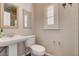 Elegant powder room with pedestal sink, decorative mirrors, and a shuttered window for natural light at 516 Arizona St, Boulder City, NV 89005