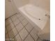 Bright bathroom featuring a clean white tub and neutral tile flooring at 5316 Clover Blossom Ct, North Las Vegas, NV 89031