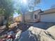 Inviting single-story home with a well-kept lawn, a two-car garage, and mature trees adding to the curb appeal at 5316 Clover Blossom Ct, North Las Vegas, NV 89031
