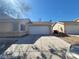 Charming single-story home featuring a two-car garage and a well-maintained driveway under a clear, sunny sky at 5316 Clover Blossom Ct, North Las Vegas, NV 89031